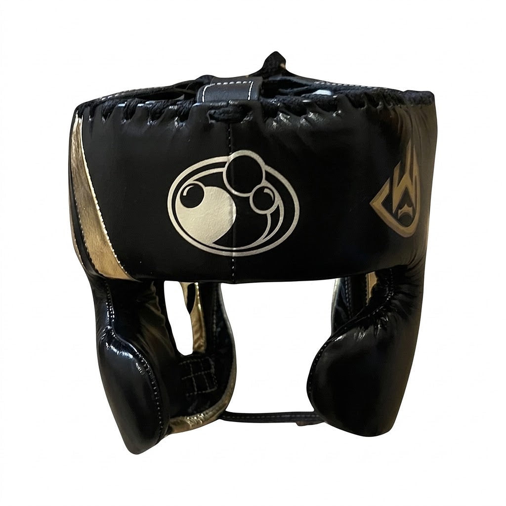 Grant black lace-up boxing gloves showing metallic gold palms, with matching black headgear and groin guard - alternate angle