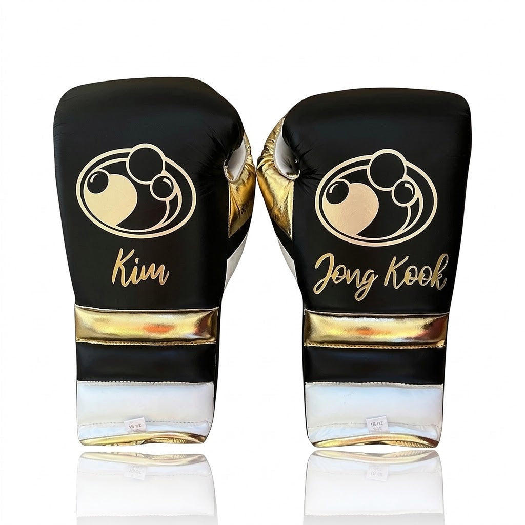 Grant black lace-up boxing gloves with gold palms and white cuffs, plus matching headgear and groin guard - side view