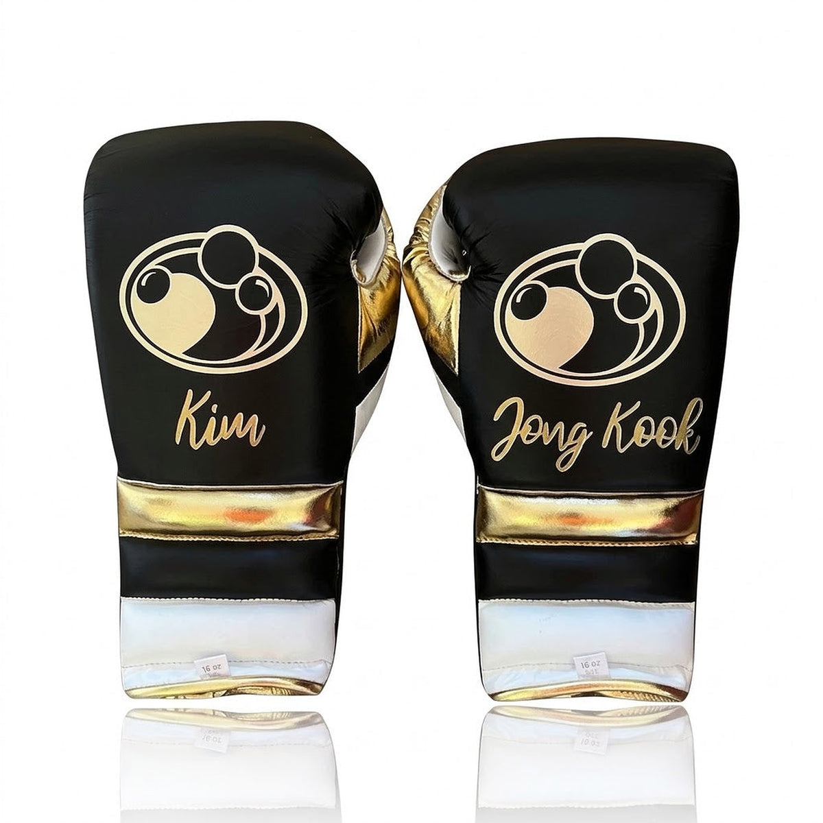 Grant black lace-up boxing gloves with gold palms and white cuffs, plus matching headgear and groin guard - side view