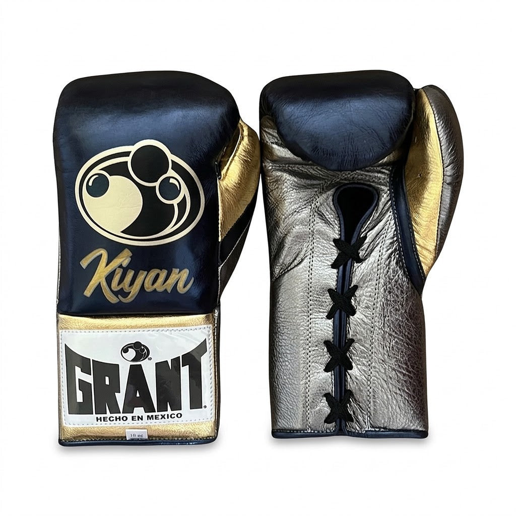 Grant navy lace-up boxing gloves with silver palms, shown with matching navy headgear and groin guard - side view