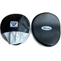 Winning focus mitts with black curved striking face and white palm side, pair laid side by side