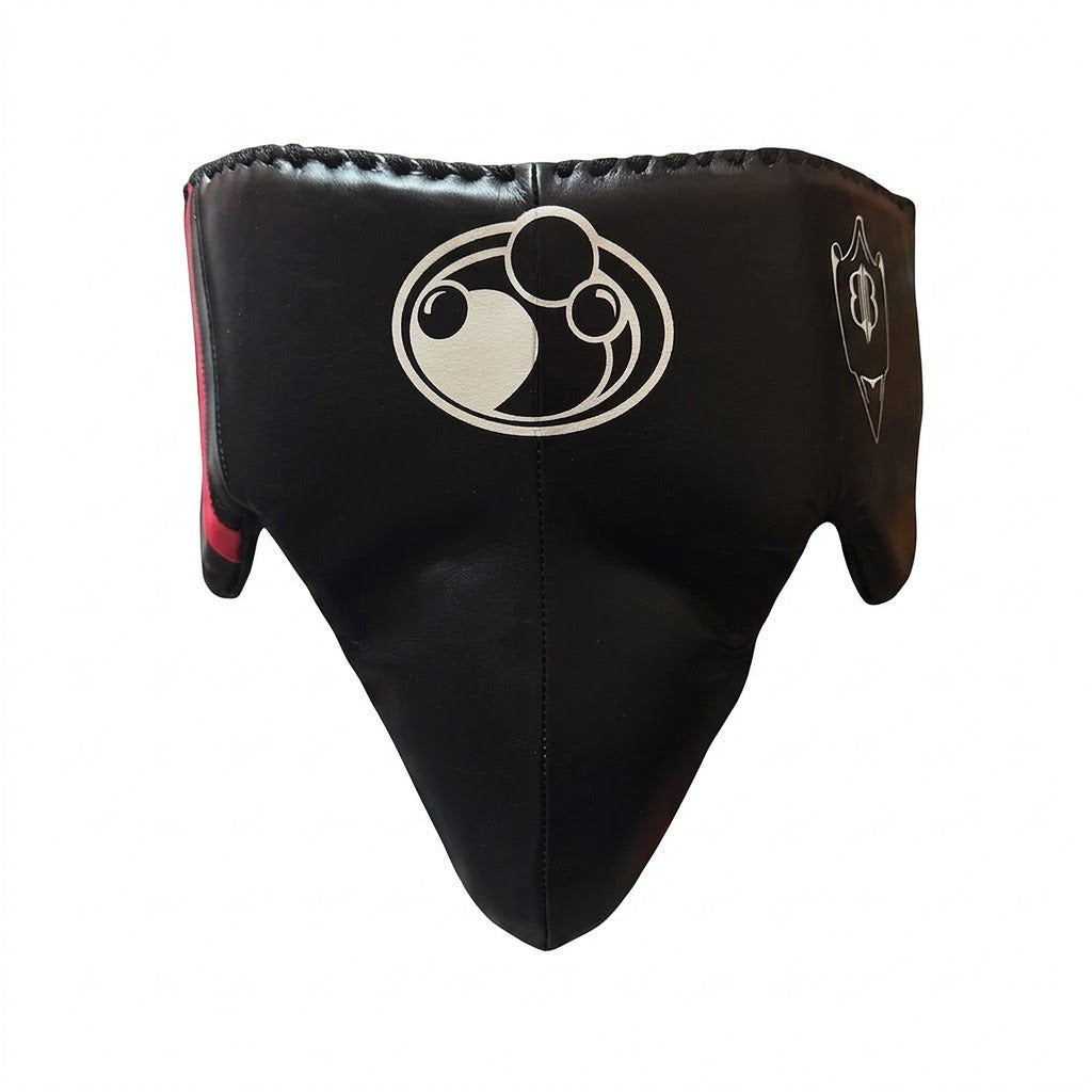 Grant black boxing set with red trim: lace-up gloves, headgear and groin guard laid out together - palm and closure detail