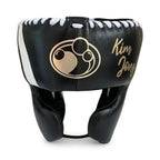 Grant black lace-up boxing gloves with gold palms and white cuffs, plus headgear and groin guard - close-up of logo and cuff