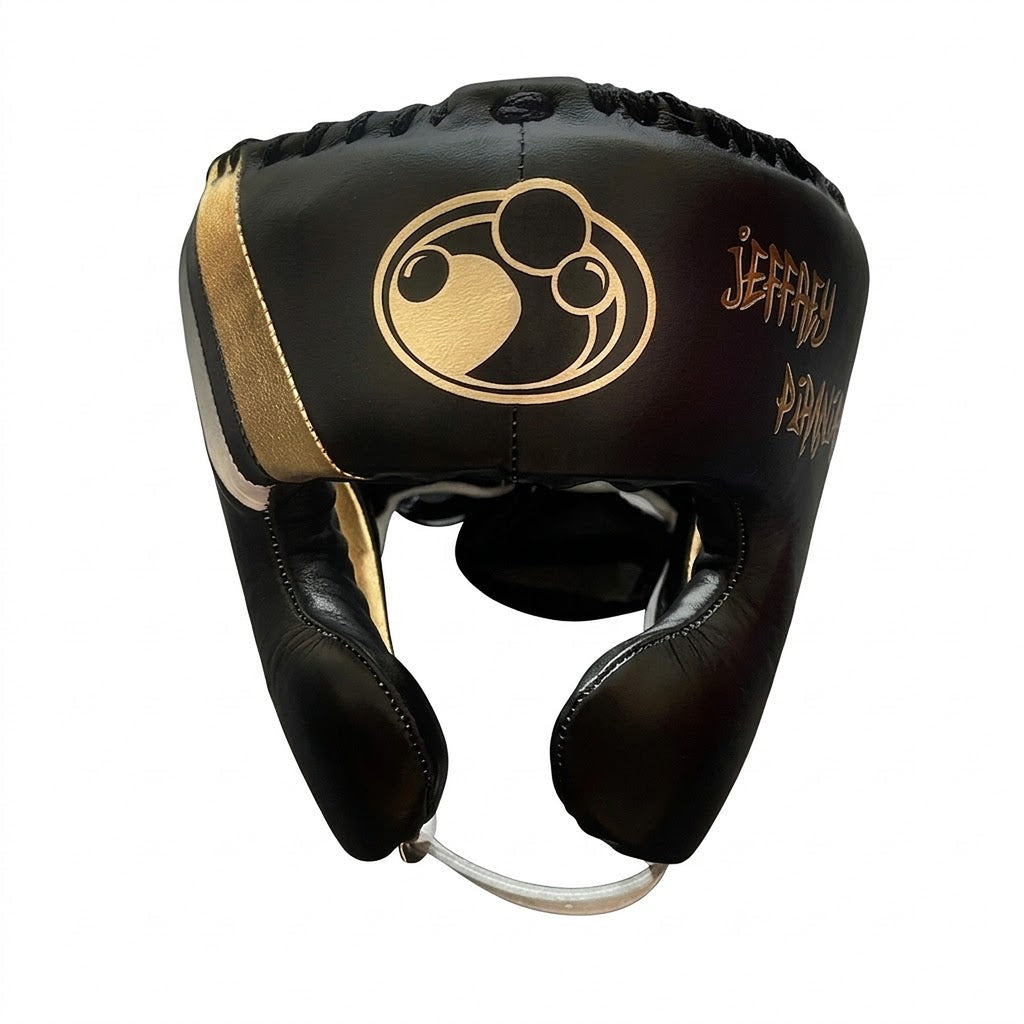 Grant brown lace-up boxing gloves with gold palms beside matching brown headgear and brown groin guard - alternate angle