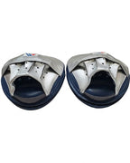 Winning metallic silver curved focus mitts with navy rim around the striking face, shown as a pair - palm side