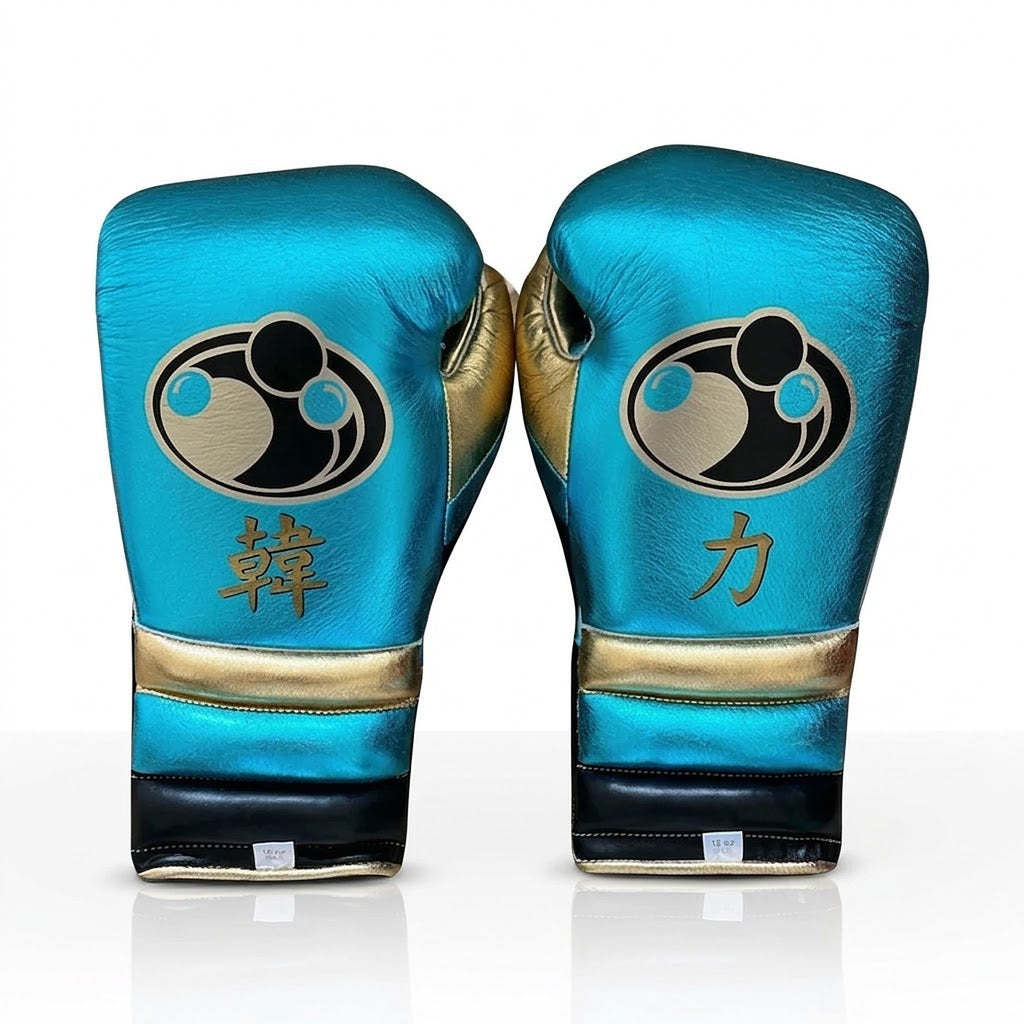 Grant metallic sky blue lace-up boxing gloves and headgear with gold accents and round Grant logo - palm and closure detail