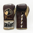 Grant brown lace-up boxing gloves with gold palms beside brown headgear and brown groin guard - close-up of logo and cuff