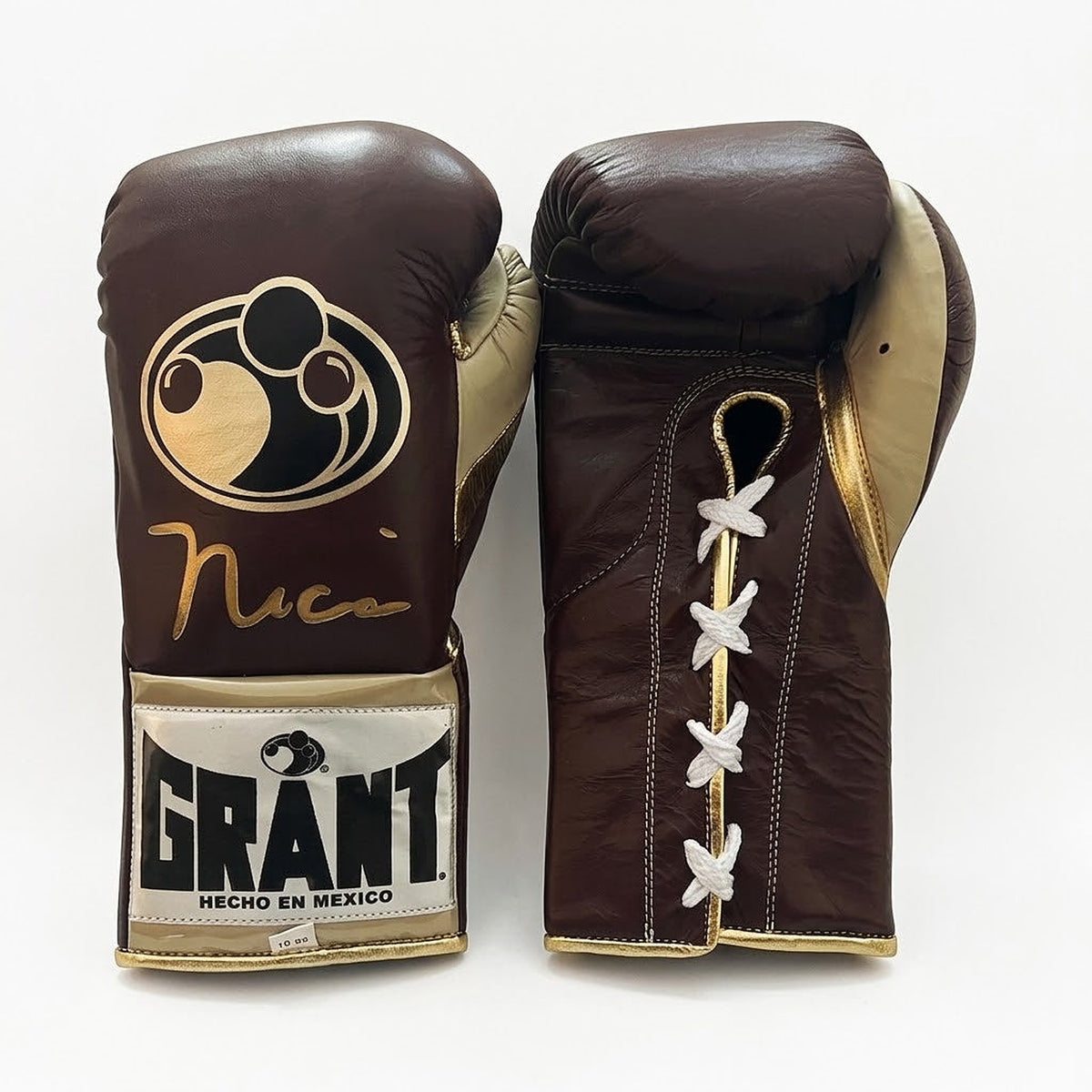 Grant brown lace-up boxing gloves with gold palms beside brown headgear and brown groin guard - close-up of logo and cuff