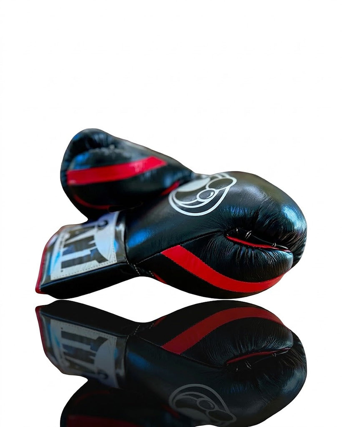 Grant all-black lace-up boxing gloves with red laces down the palm and red inner lining visible - close-up of logo and cuff