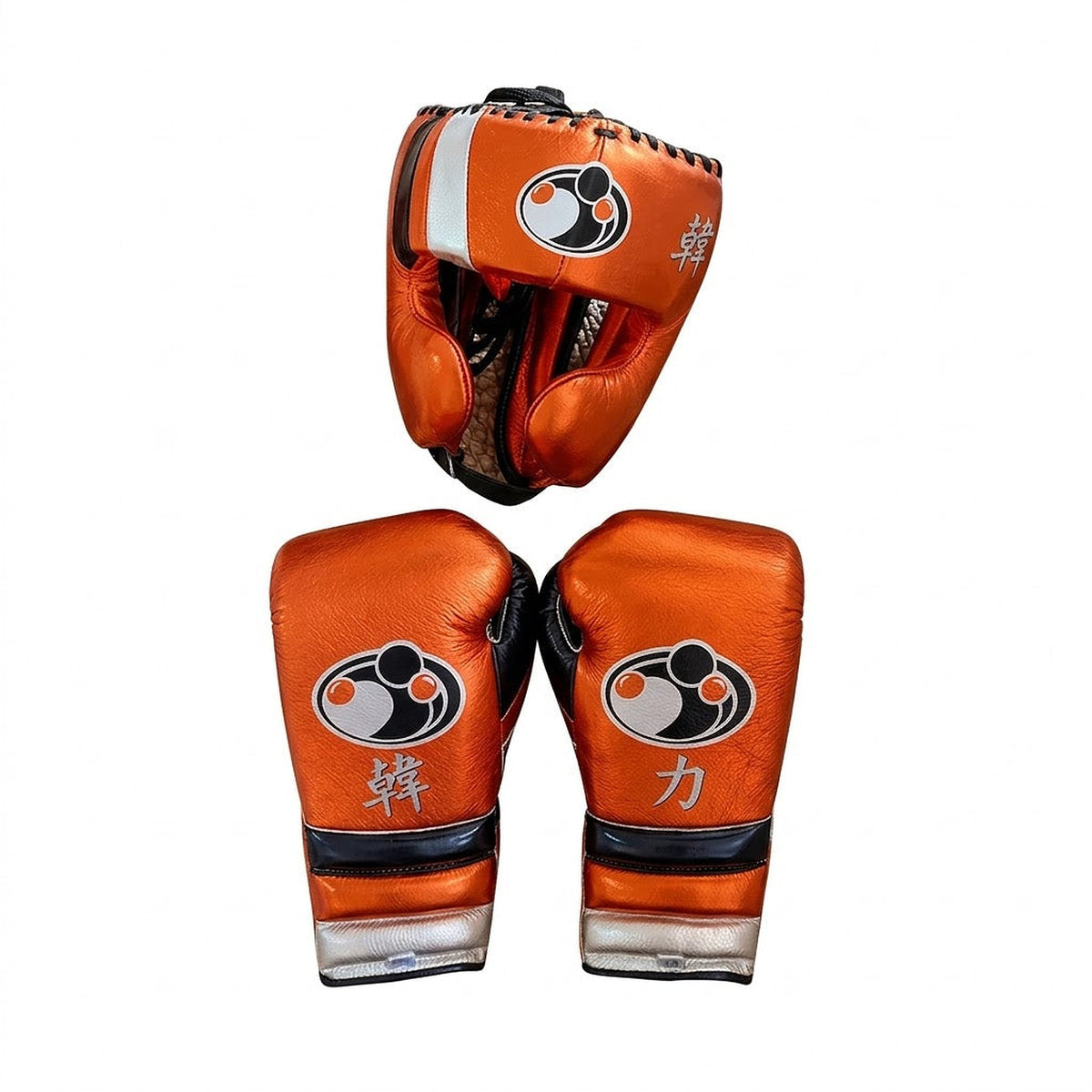Grant metallic orange lace-up boxing gloves with silver cuffs alongside matching orange headgear