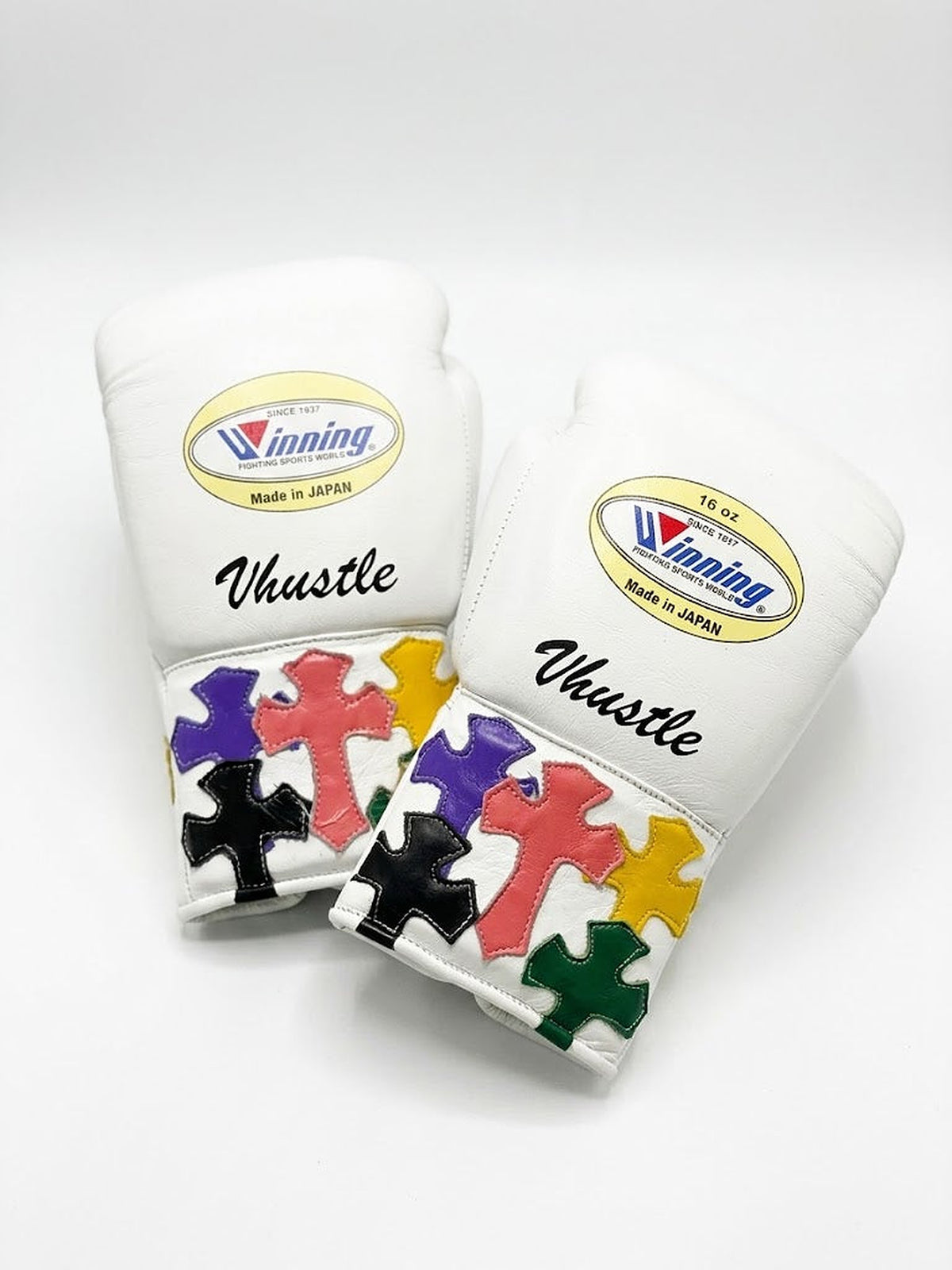 Winning white boxing set with multicolor cross patches on lace-up gloves, headgear and groin guard - palm and closure detail
