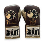 Grant brown lace-up boxing gloves with gold palms beside brown headgear and brown groin guard - palm and closure detail