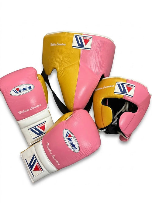 Winning boxing set with pink and white lace-up gloves, gold headgear and gold groin guard