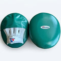 Winning emerald green curved focus mitts with white palm sides, displayed as a left and right pair