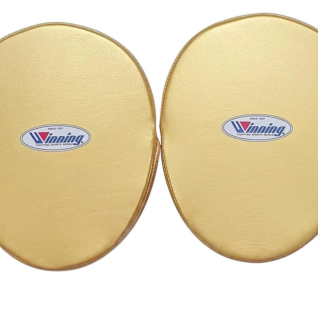 Pair of Winning black curved focus mitts with gold palm and gold rim around the striking face - side view