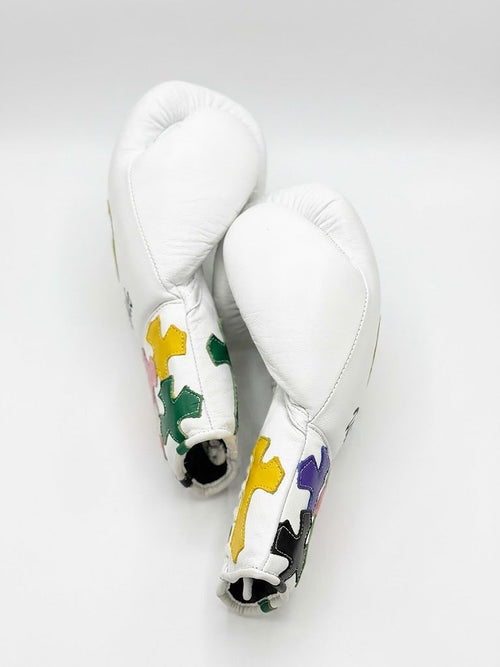 Winning white boxing set with multicolor cross patches on lace-up gloves, headgear and groin guard - side view