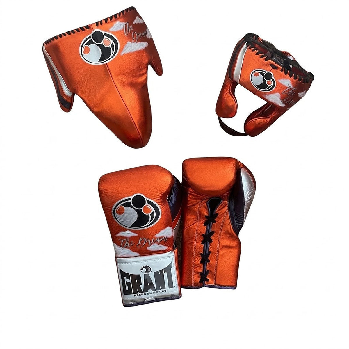 Grant metallic orange lace-up gloves with silver GRANT cuff patch, matching orange headgear and groin guard