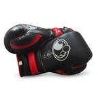 Grant black boxing set with red trim including lace-up gloves, headgear and groin guard laid out together - alternate angle