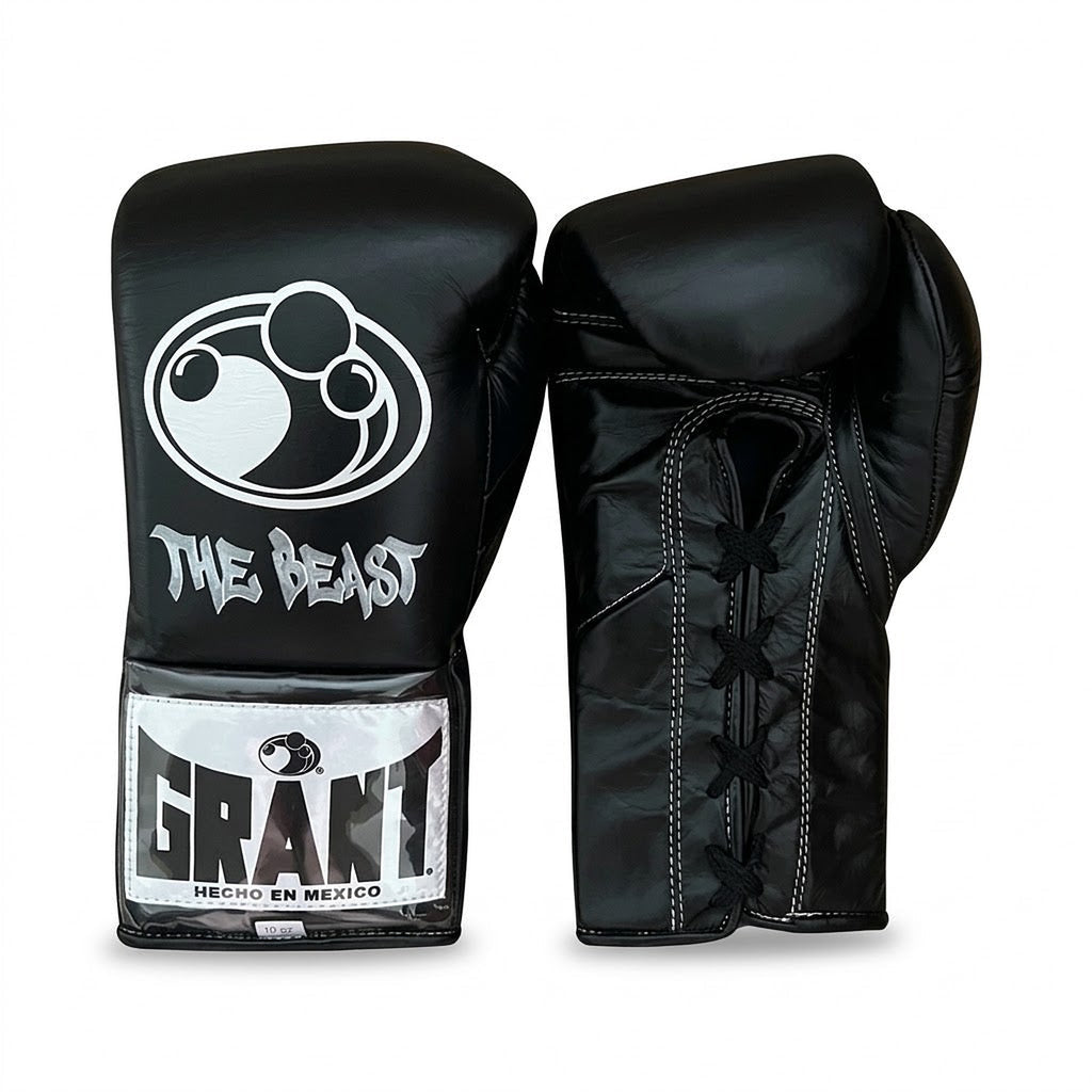 Grant all-black lace-up boxing gloves, black headgear and black groin guard laid out as a complete set - side view