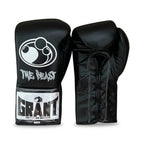 Grant all-black lace-up boxing gloves, black headgear and black groin guard laid out as a complete set - side view