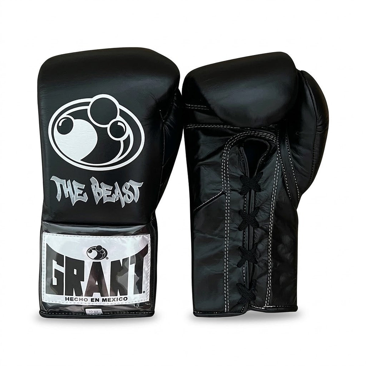 Grant all-black lace-up boxing gloves, black headgear and black groin guard laid out as a complete set - side view