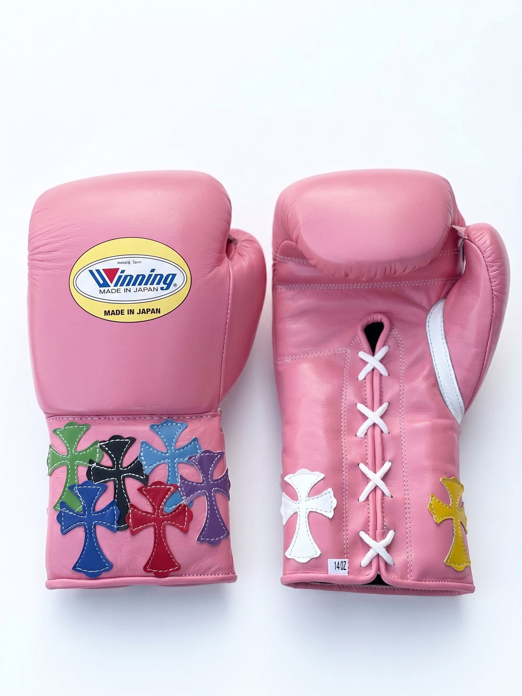 Winning pink lace-up boxing glove with multicolor cross patches around the cuff and wrist area - alternate angle
