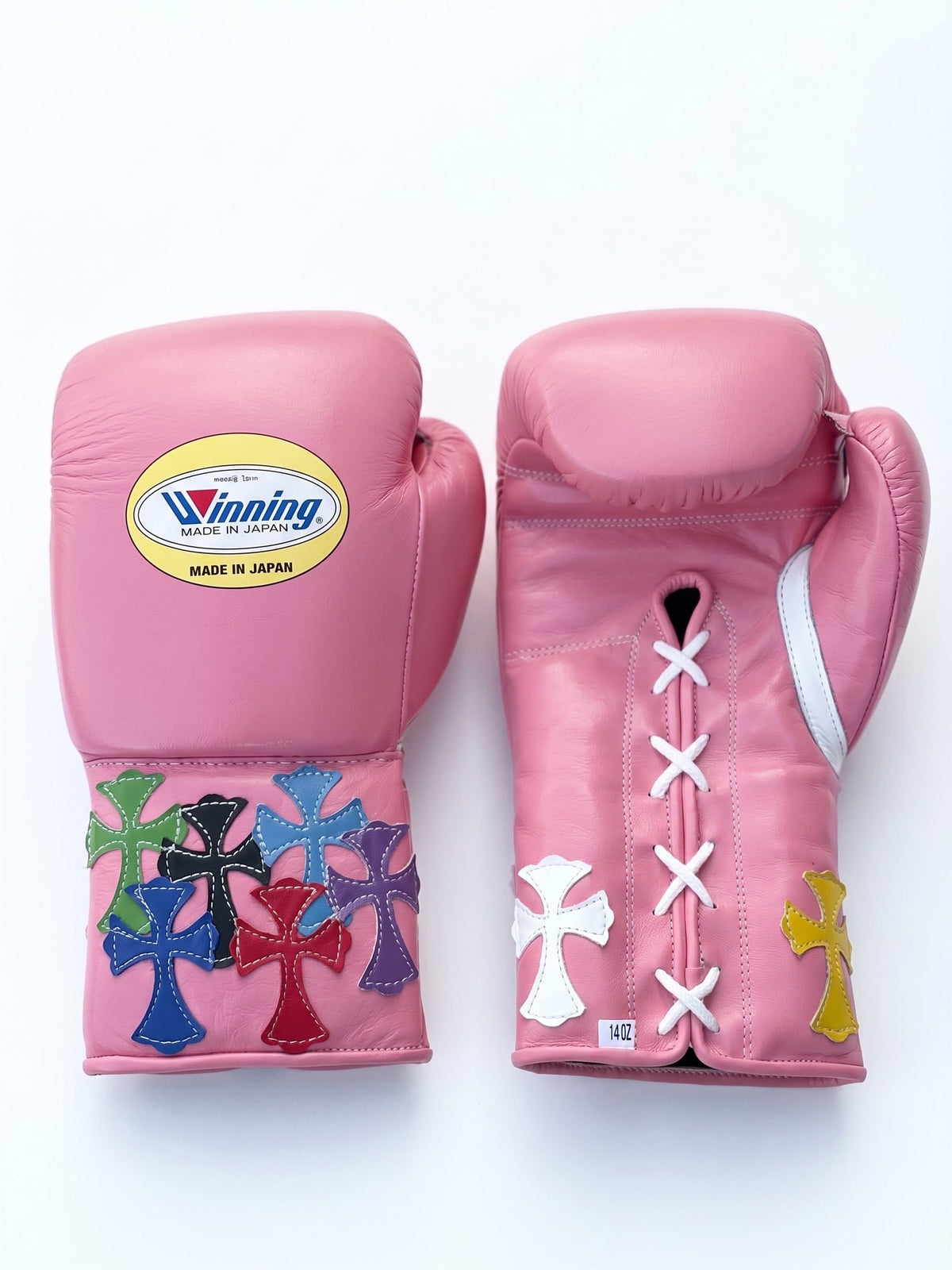 Winning pink lace-up boxing glove with multicolor cross patches around the cuff and wrist area - alternate angle