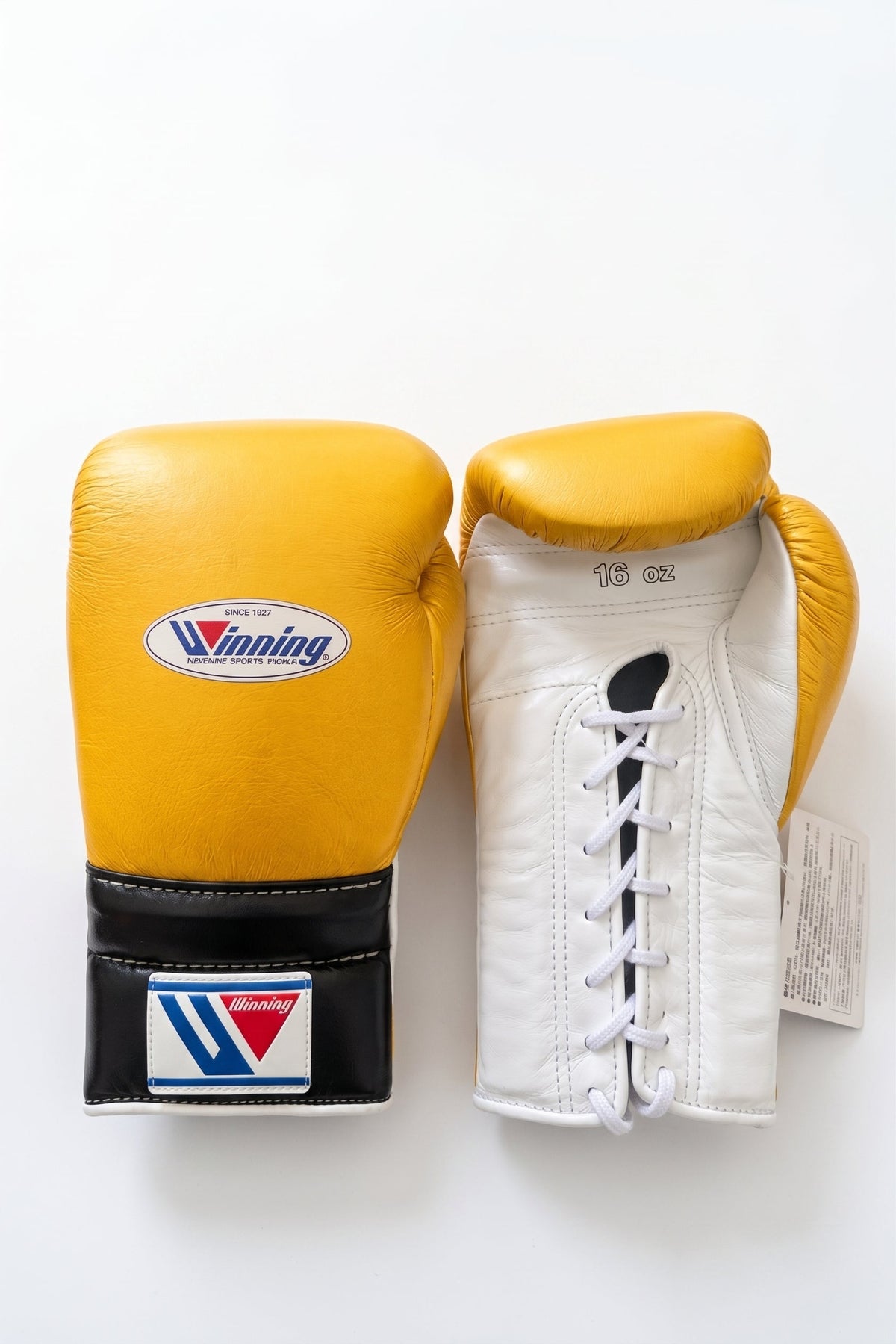 Winning lace-up boxing glove with a yellow back, white palm and black cuff in a bright three-tone design