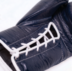 Winning MS-600 lace-up boxing glove in full navy blue leather with a visible textured surface finish - side view