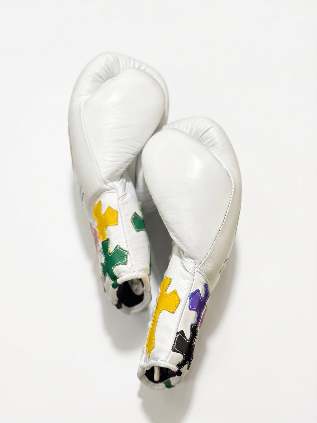 Winning white boxing gloves with multicolor cross patches on the cuff and a sample script name print - palm and closure