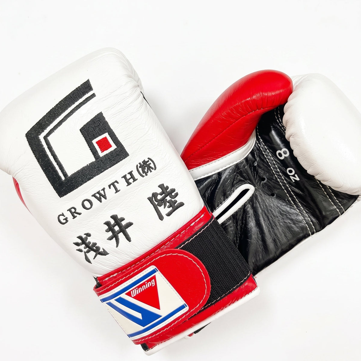 Winning white Velcro boxing glove with black graphic print, sample name lettering and a red palm