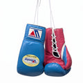 Winning royal blue boxing gloves with red palm, shown hanging by their laces