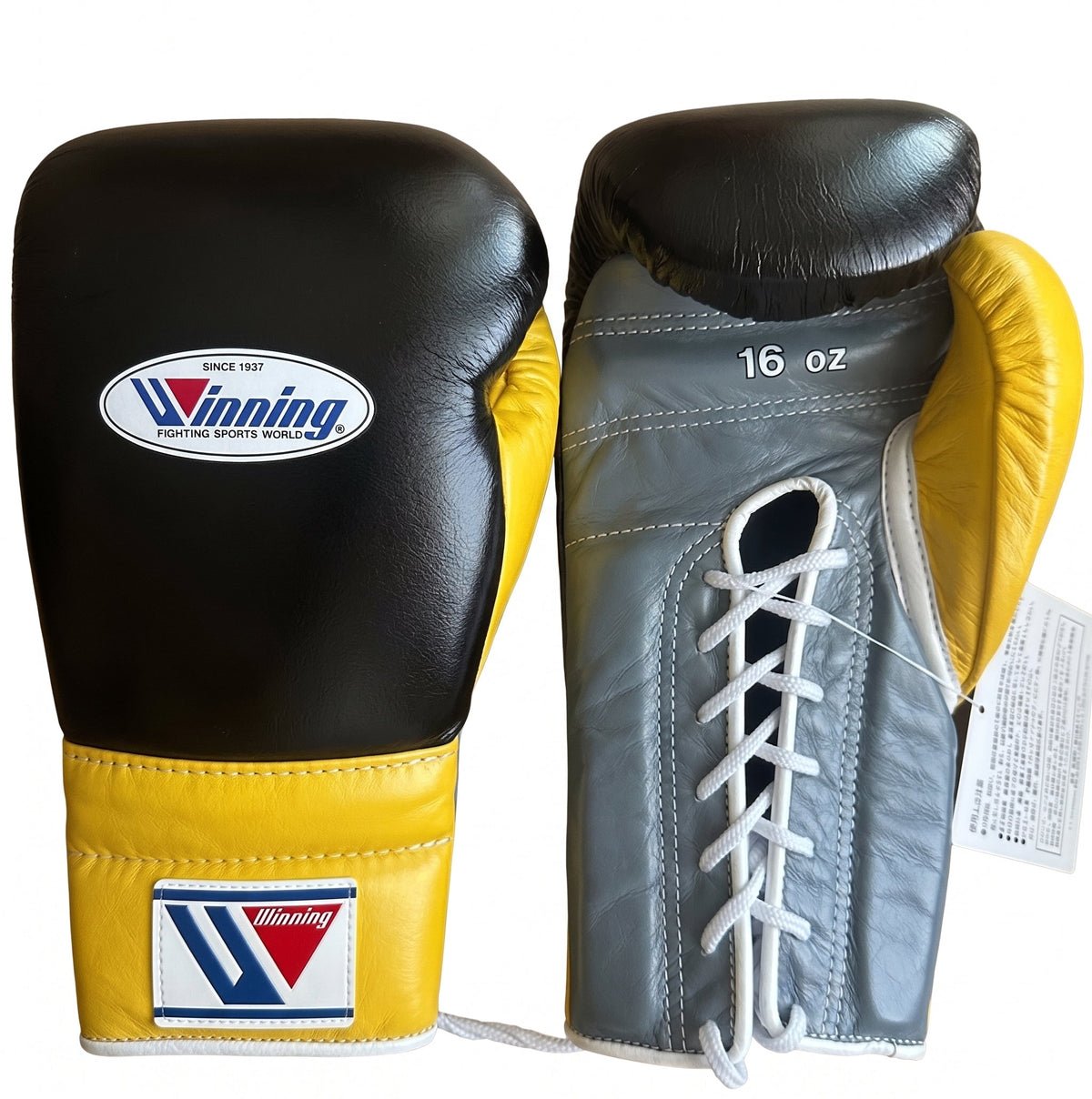 Winning black boxing gloves with gray palm and bright yellow cuff, laced up at the wrist