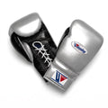 Winning lace-up boxing glove with a reflective metallic silver back and black palm, laced at the wrist