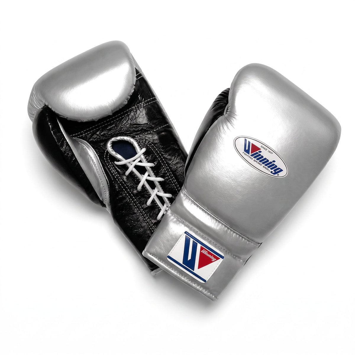 Winning lace-up boxing glove with a reflective metallic silver back and black palm, laced at the wrist
