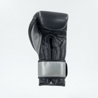 Side view of a Cleto Reyes black boxing glove showing the metallic silver cuff detail