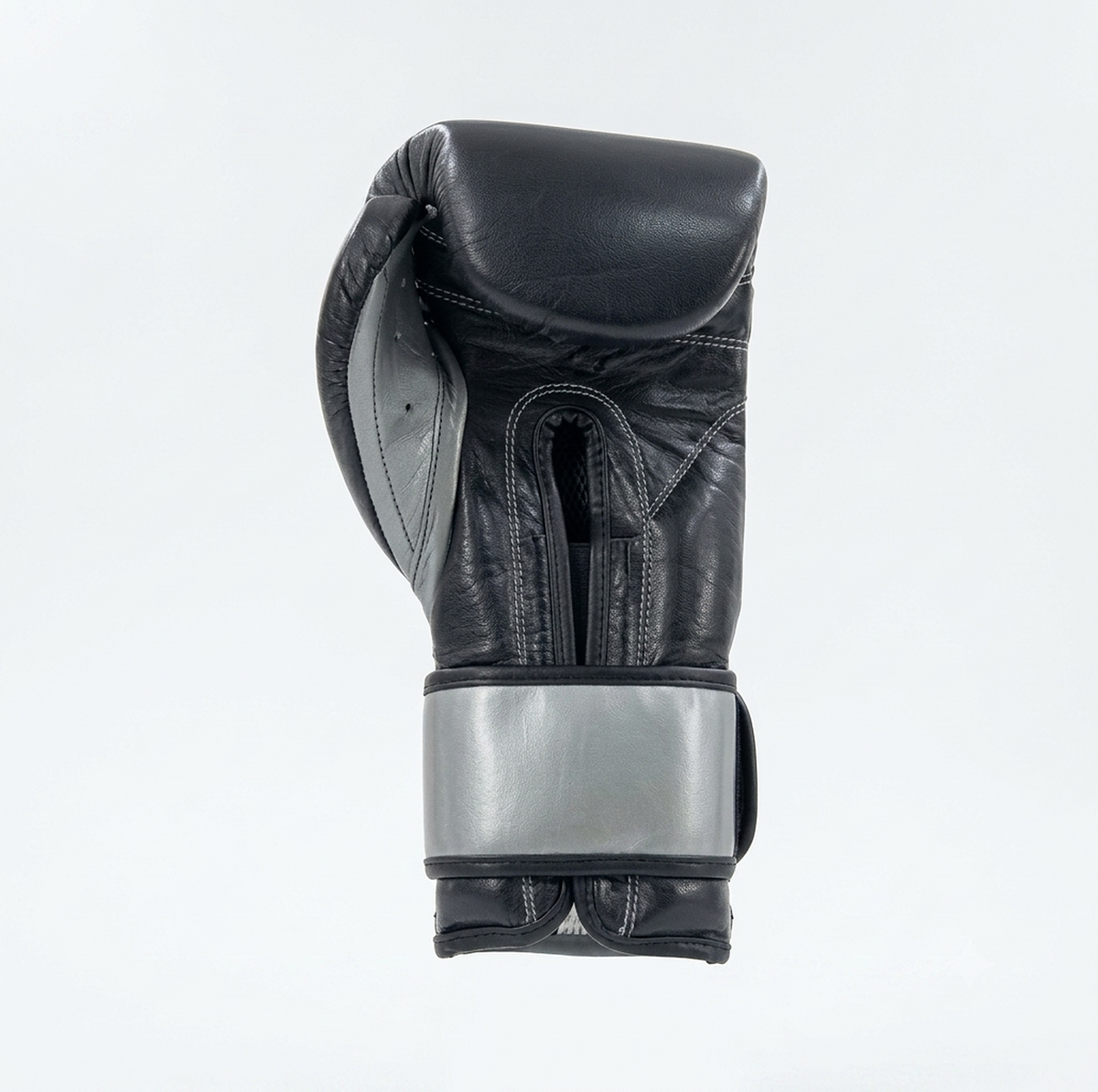 Side view of a Cleto Reyes black boxing glove showing the metallic silver cuff detail