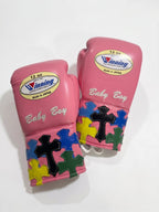 Winning pink lace-up boxing glove with multicolor cross patches around the cuff and wrist area - palm and closure detail
