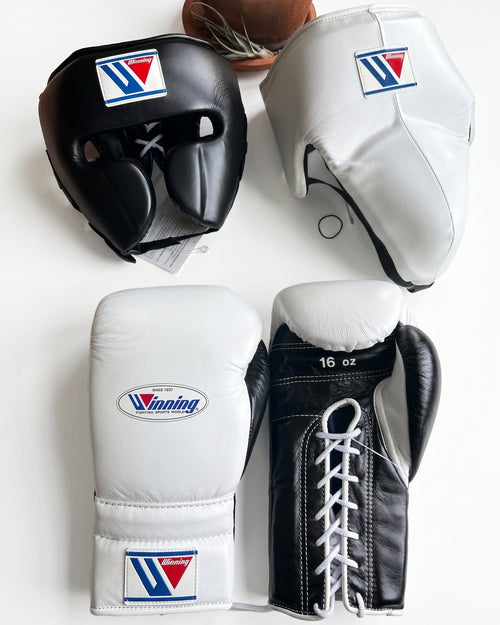 Winning boxing set with white and black lace-up gloves, black headgear and white groin guard