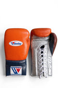 Winning orange boxing gloves with a silver palm and navy cuff, laced at the wrist