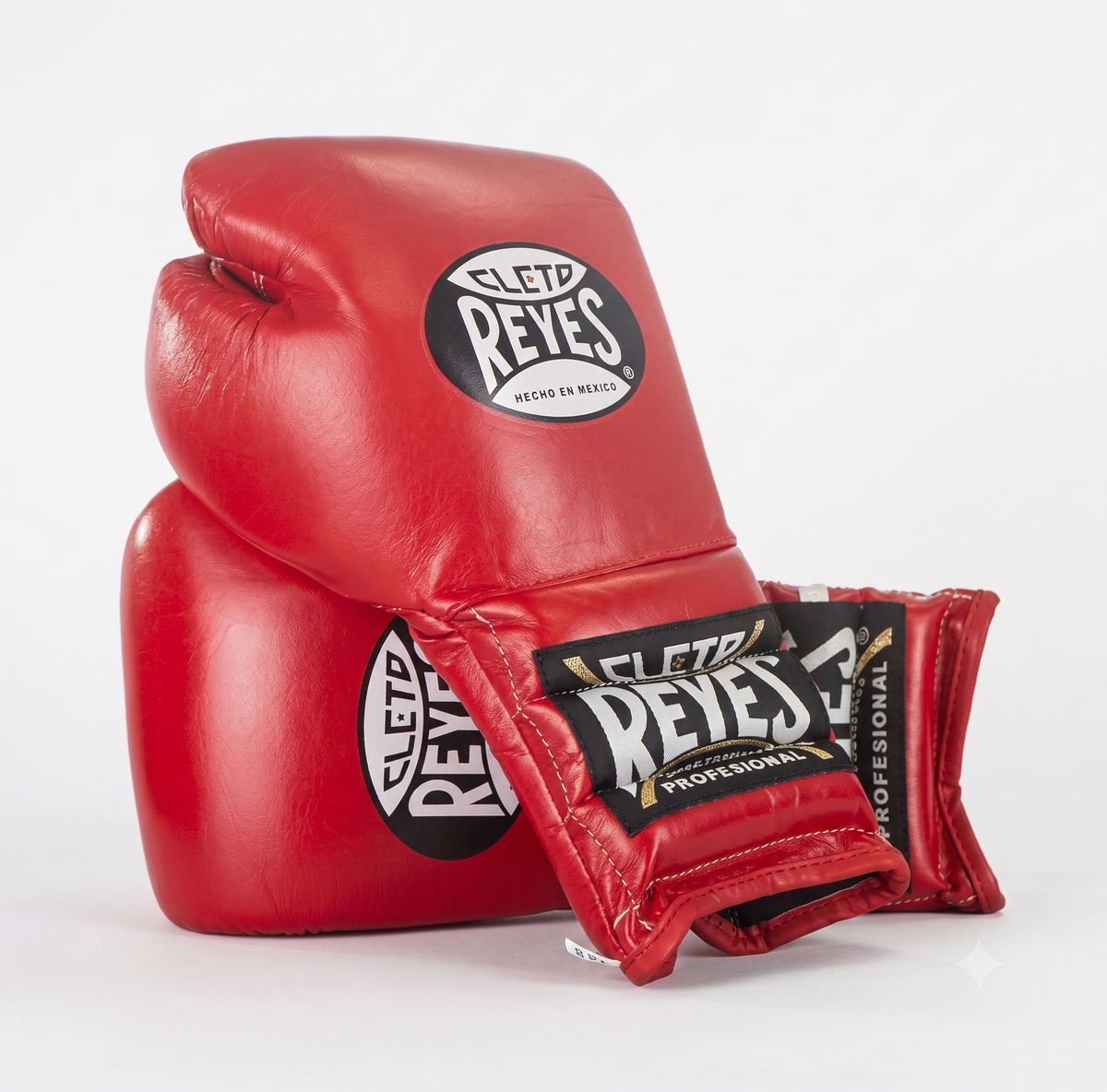 Cleto Reyes red leather boxing gloves stacked, showing brand patches on the back and wrist