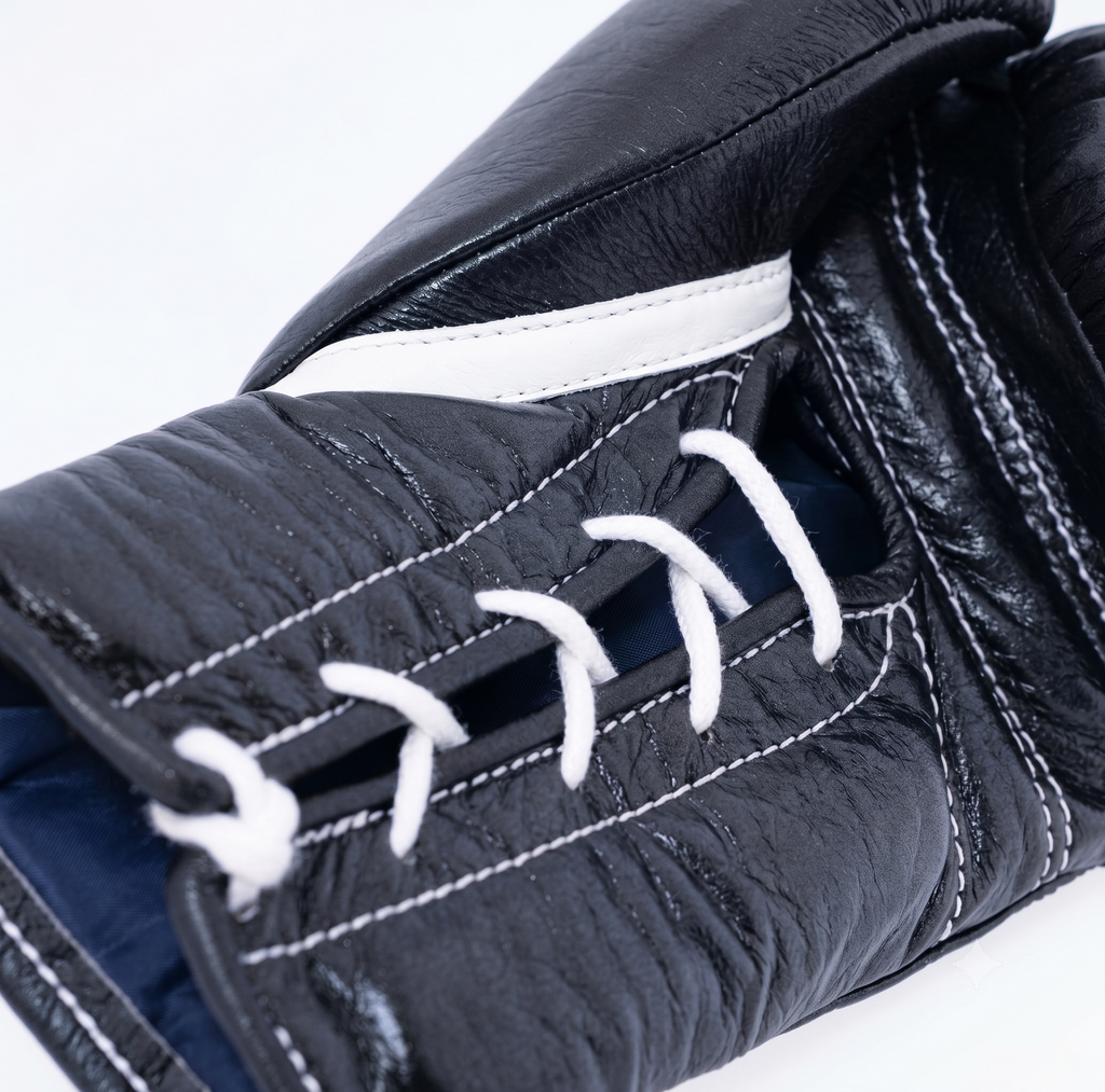 Winning MS-600 black boxing gloves with white laces and red, white and blue W logo on the cuff - side view