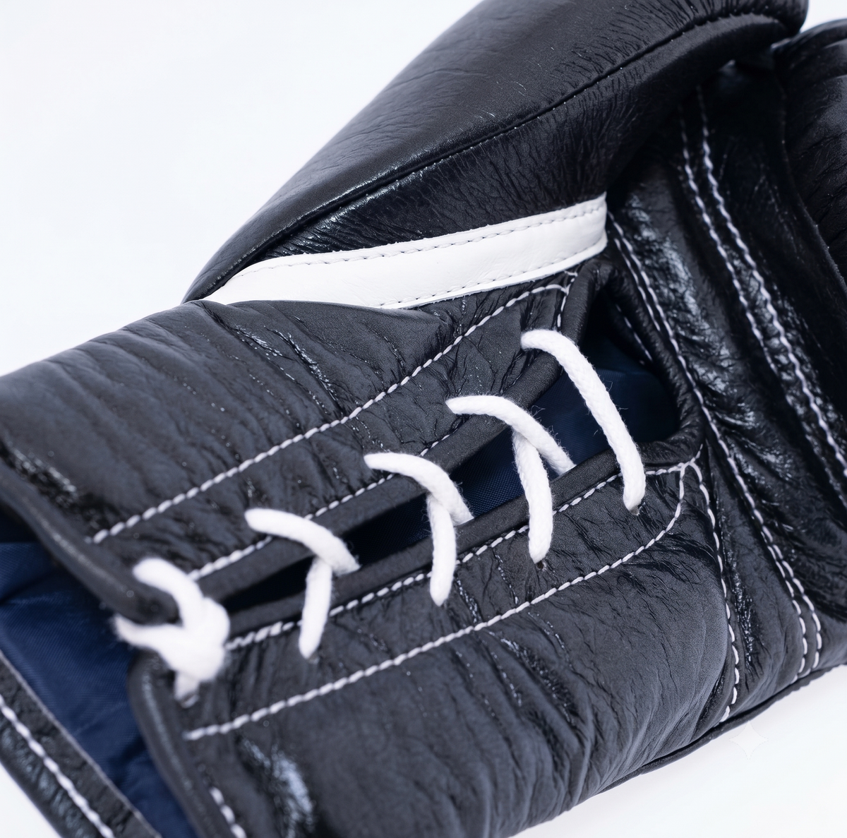 Winning MS-600 black boxing gloves with white laces and red, white and blue W logo on the cuff - side view