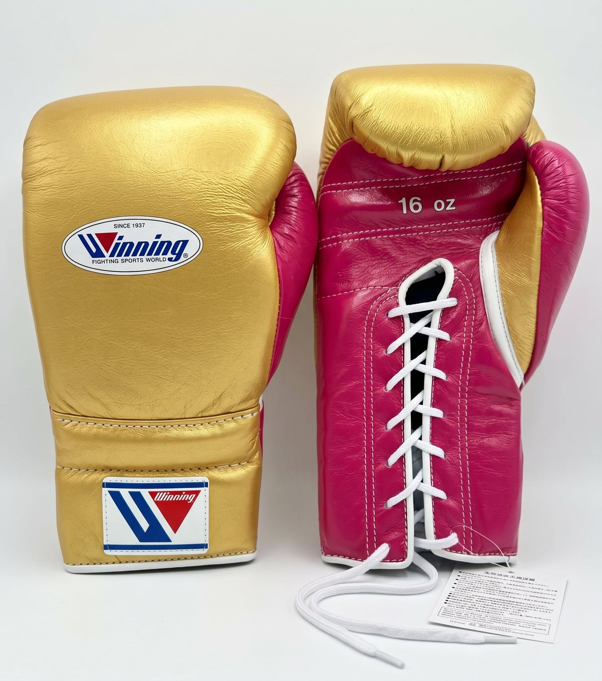 Winning lace-up boxing glove with metallic gold back and a magenta pink palm