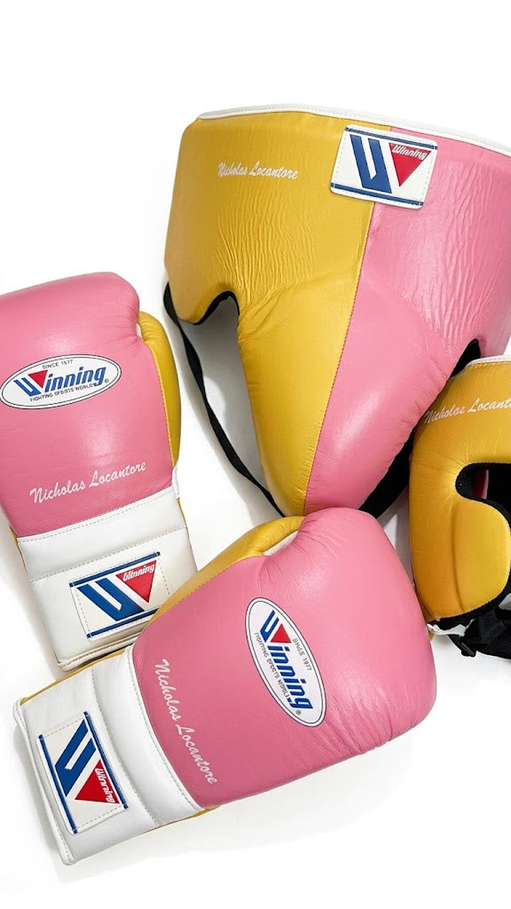 Winning boxing set with pink and white lace-up gloves, gold headgear and gold groin guard - side view