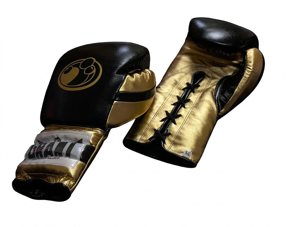Grant black and metallic gold two-tone boxing gloves with black laces on gold palm and gold cuff logo patch - side view