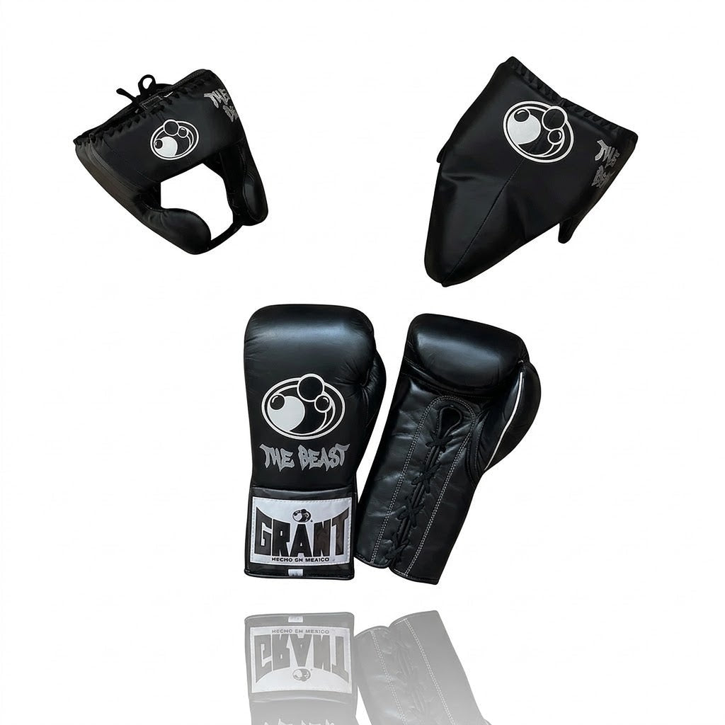 Grant all-black lace-up boxing gloves, black headgear and black groin guard laid out as a complete set