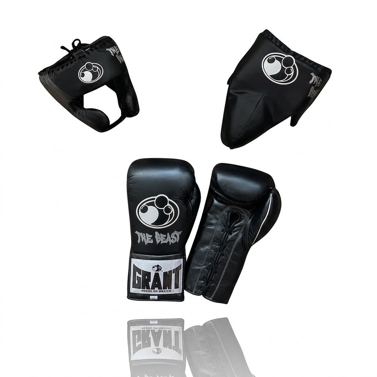 Grant all-black lace-up boxing gloves, black headgear and black groin guard laid out as a complete set