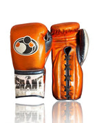 Grant metallic orange lace-up boxing gloves with silver cuff band and black laces on the palm side