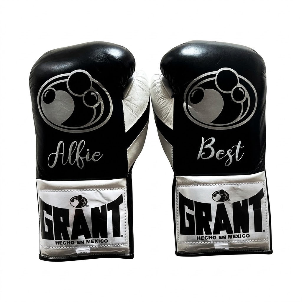 Grant black lace-up boxing gloves, headgear and groin guard with silver cuff patches and sample name prints - side view